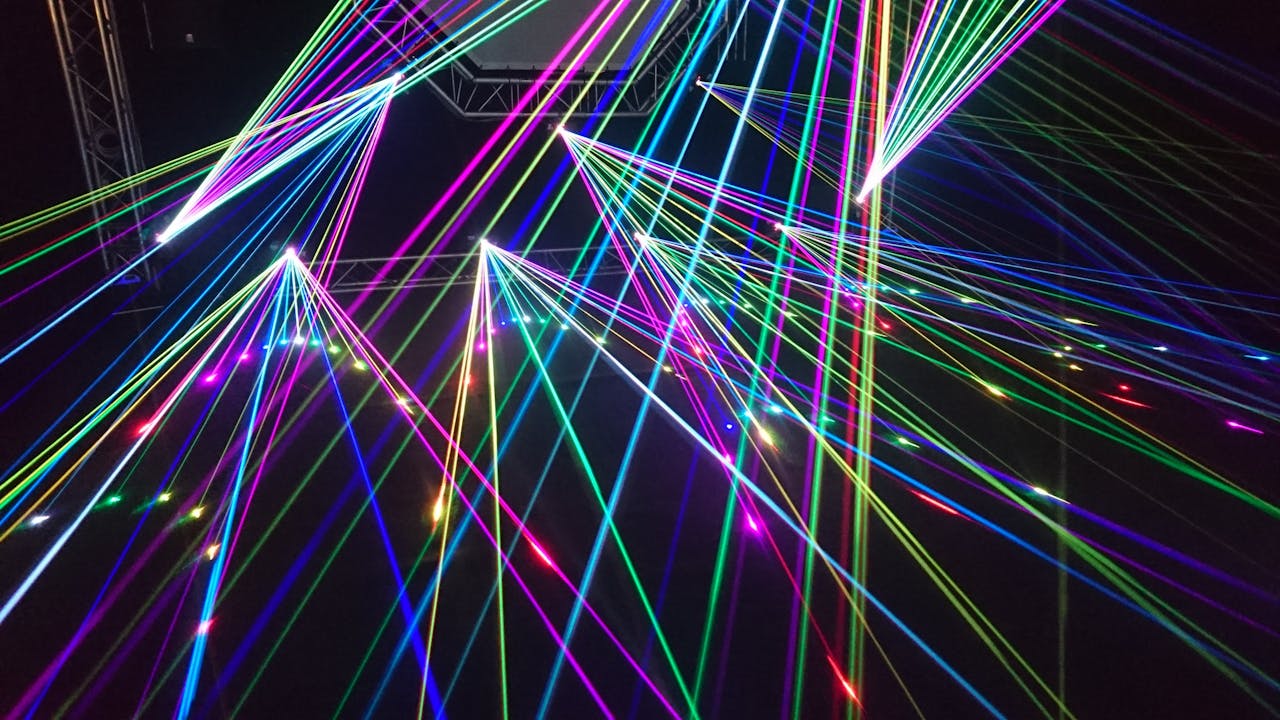 services-02 Dynamic multicolor laser beams create an electrifying display in a nighttime laser show.